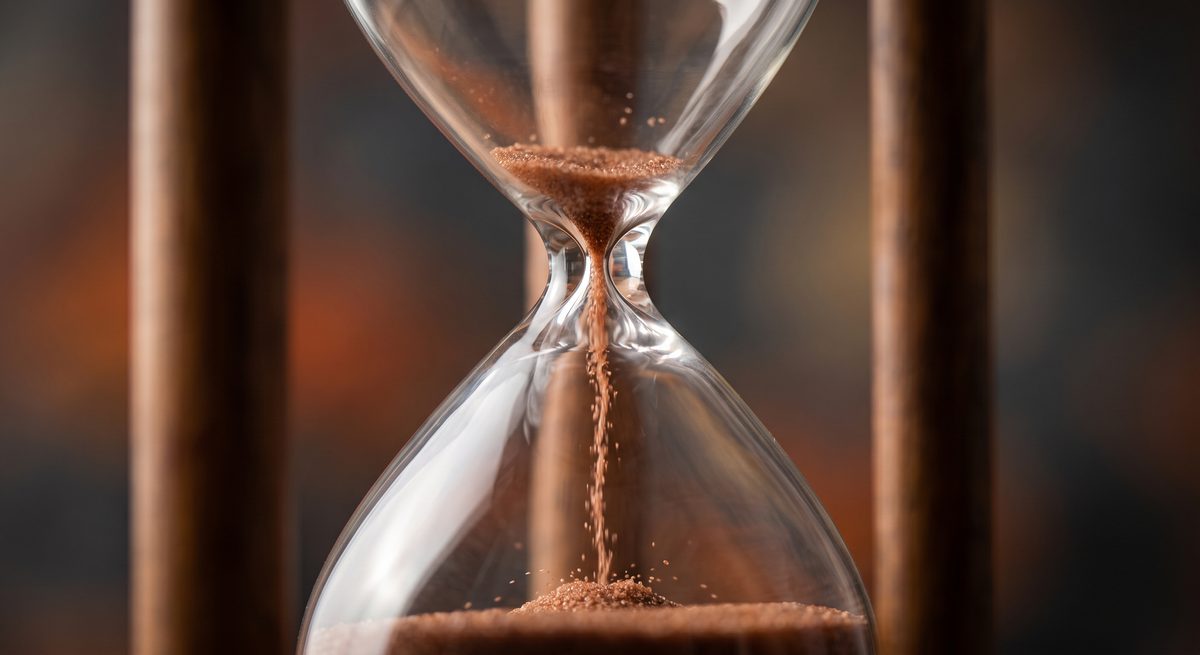An hourglass with sand running out